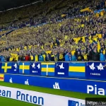 Home 23 스포츠 팬 기반 분석과 활용 사례 - A modern Swedish football stadium filled with enthusiastic fans using interactive mobile apps during...